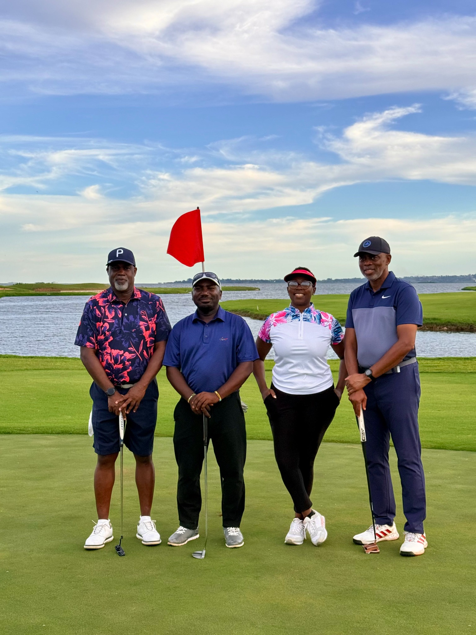 Group of golfers standing near a flag on the green