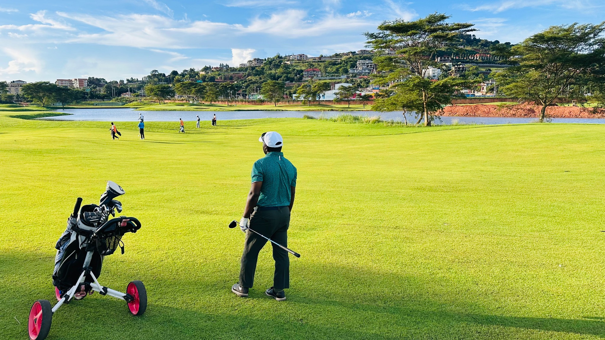 Golfer standing on a fairway overlooking a golf course