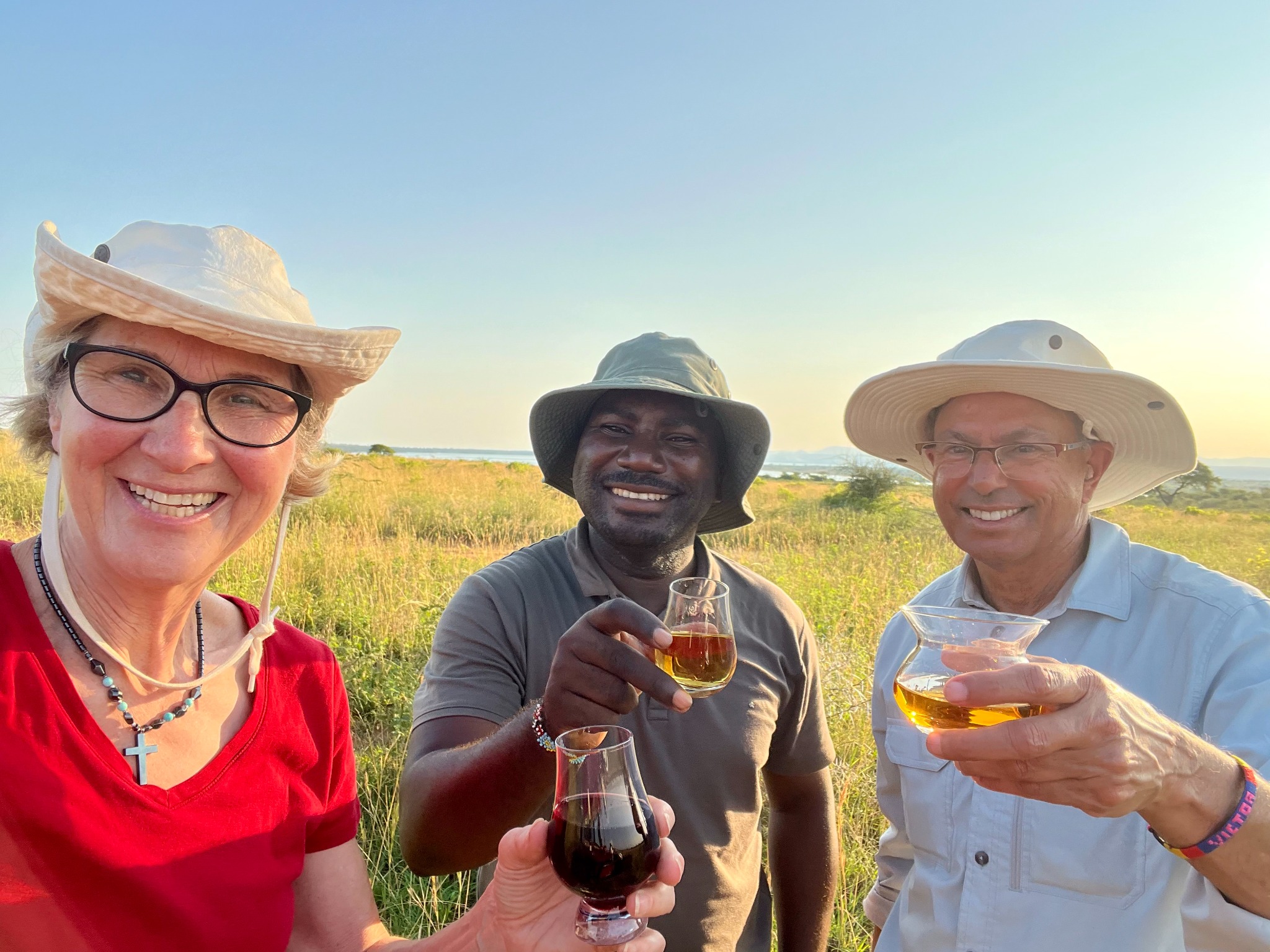 Travellers and guide sharing a toast during a safari experience